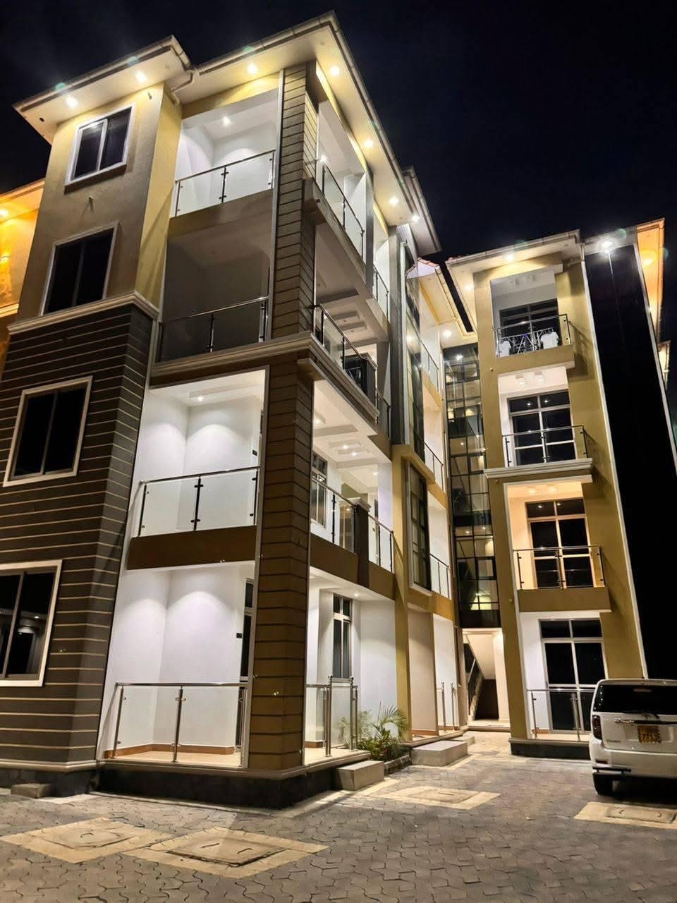 SN Suites Apartments building exterior at night